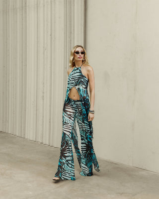 WHO IS SHE PANTS IN GREEN ANIMAL PRINT